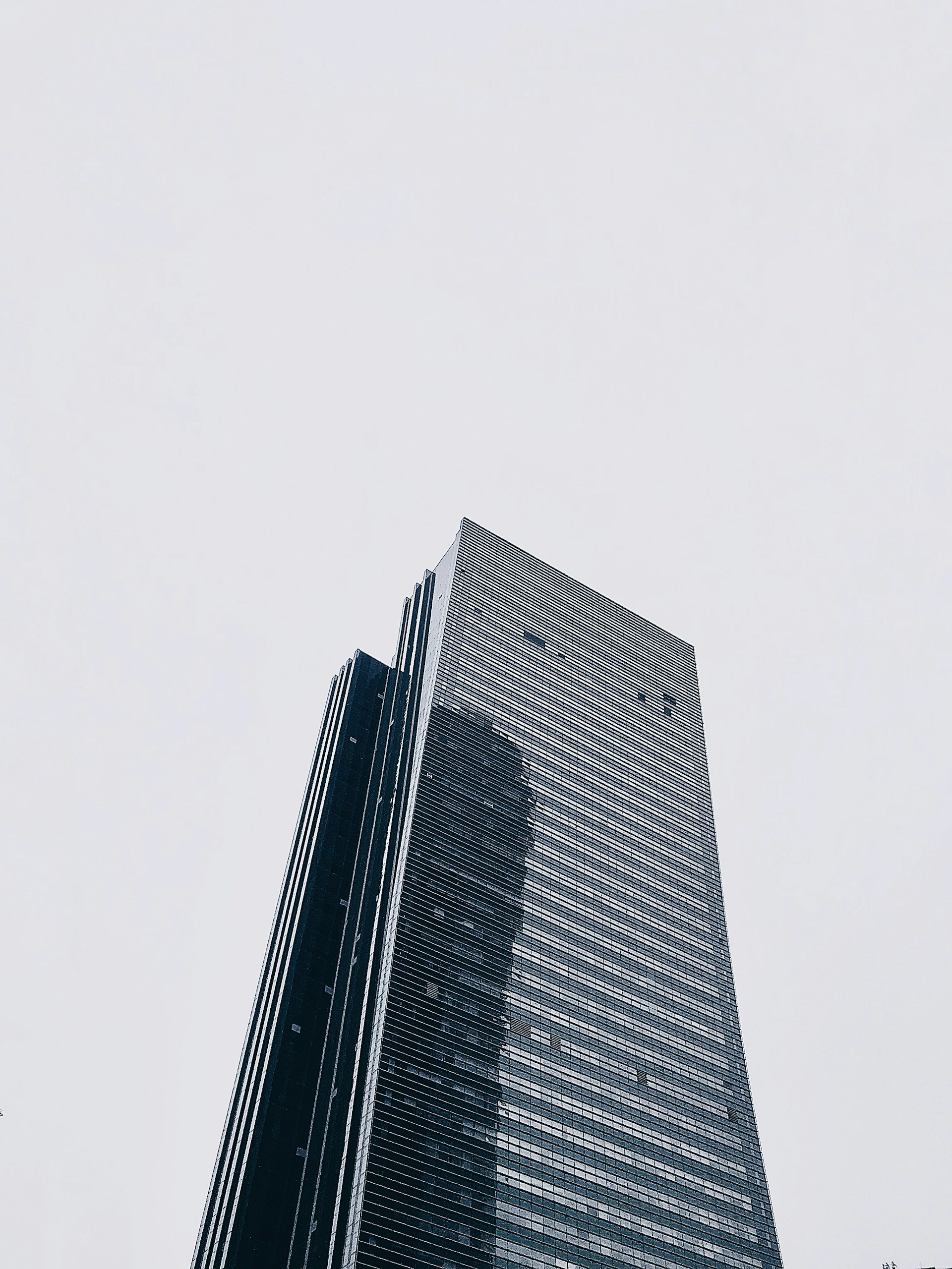 Glass skyscraper against overcast sky